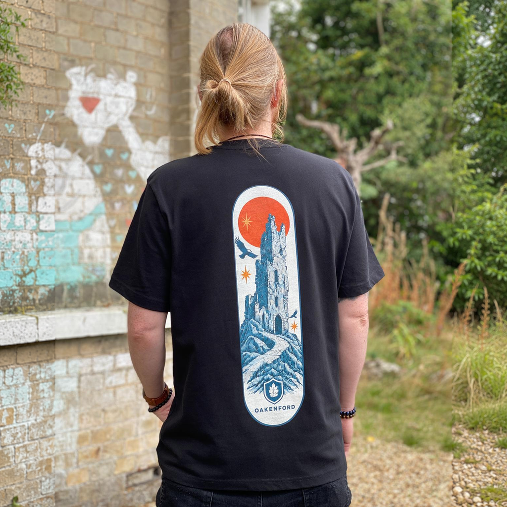 Model wearing the Fallen Tower Oakenford graphic T-shirt, with full head and tee hem visible