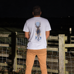 White Night Stag T-shirt worn outdoors beside a wooden fence at night, back view