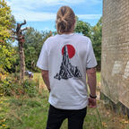 Model wearing the white The Sea Spire Oakenford T-shirt, showing the back print