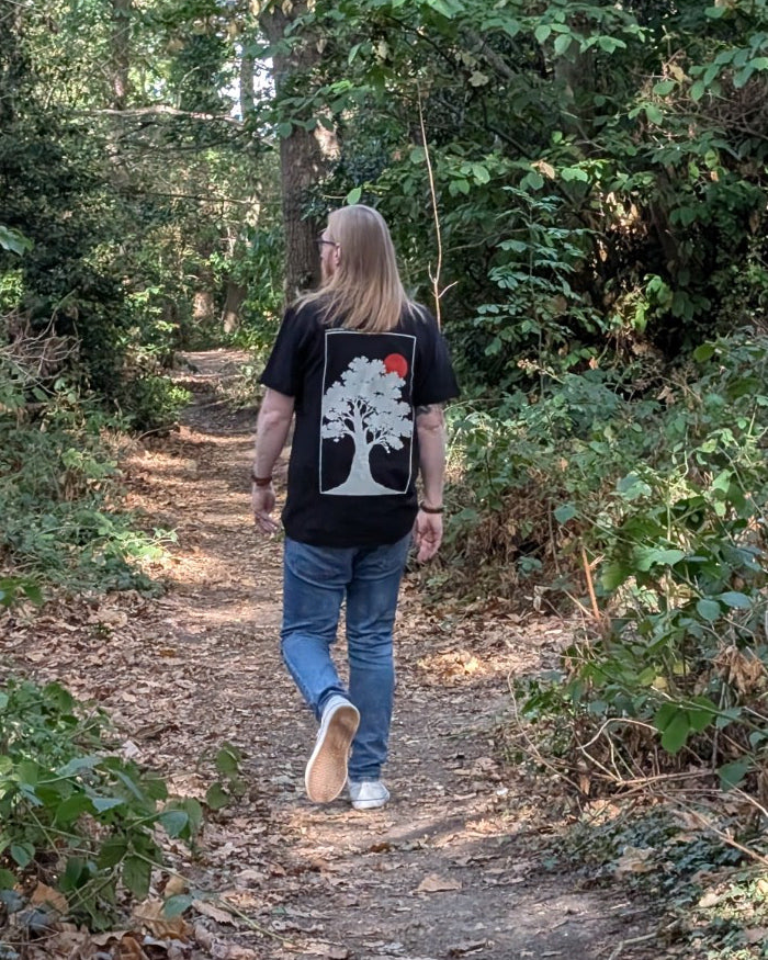 The Old Oak black tee worn walking along a woodland path